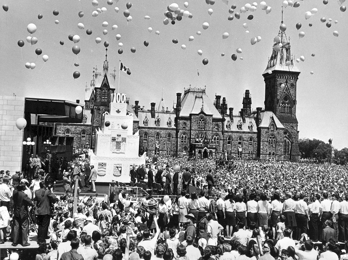 July 1, 1967 – Parliament Hill in Ottawa was packed as hundreds of coloured balloons were released after the Queen cut the 30-foot-high birthday cake.
