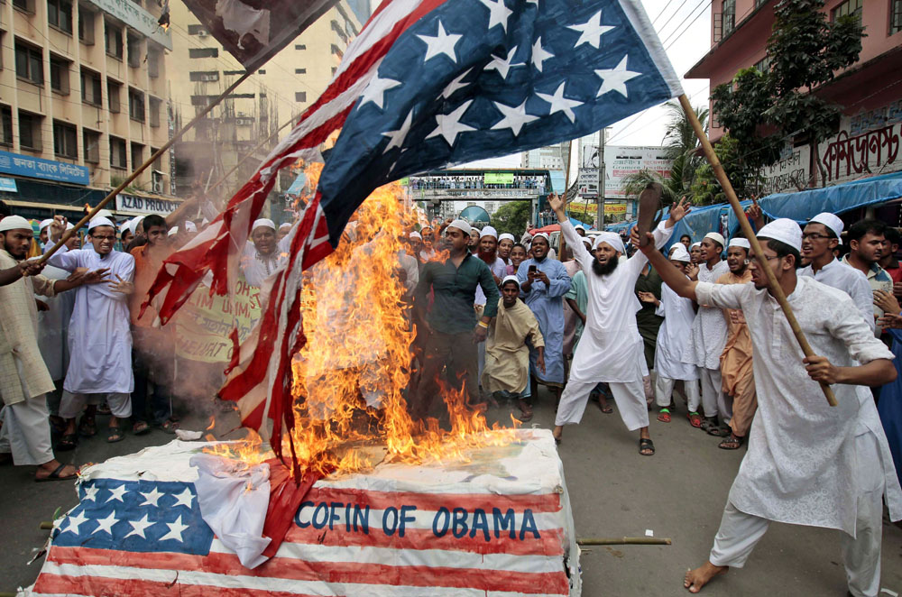Bangladeshi Muslims burn a U.S. flag and a coffin of then-U.S. president Barack Obama during a protest in Dhaka, Bangladesh, in September of 2012 (not a protest against current U.S. President Donald Trump in 2017).
