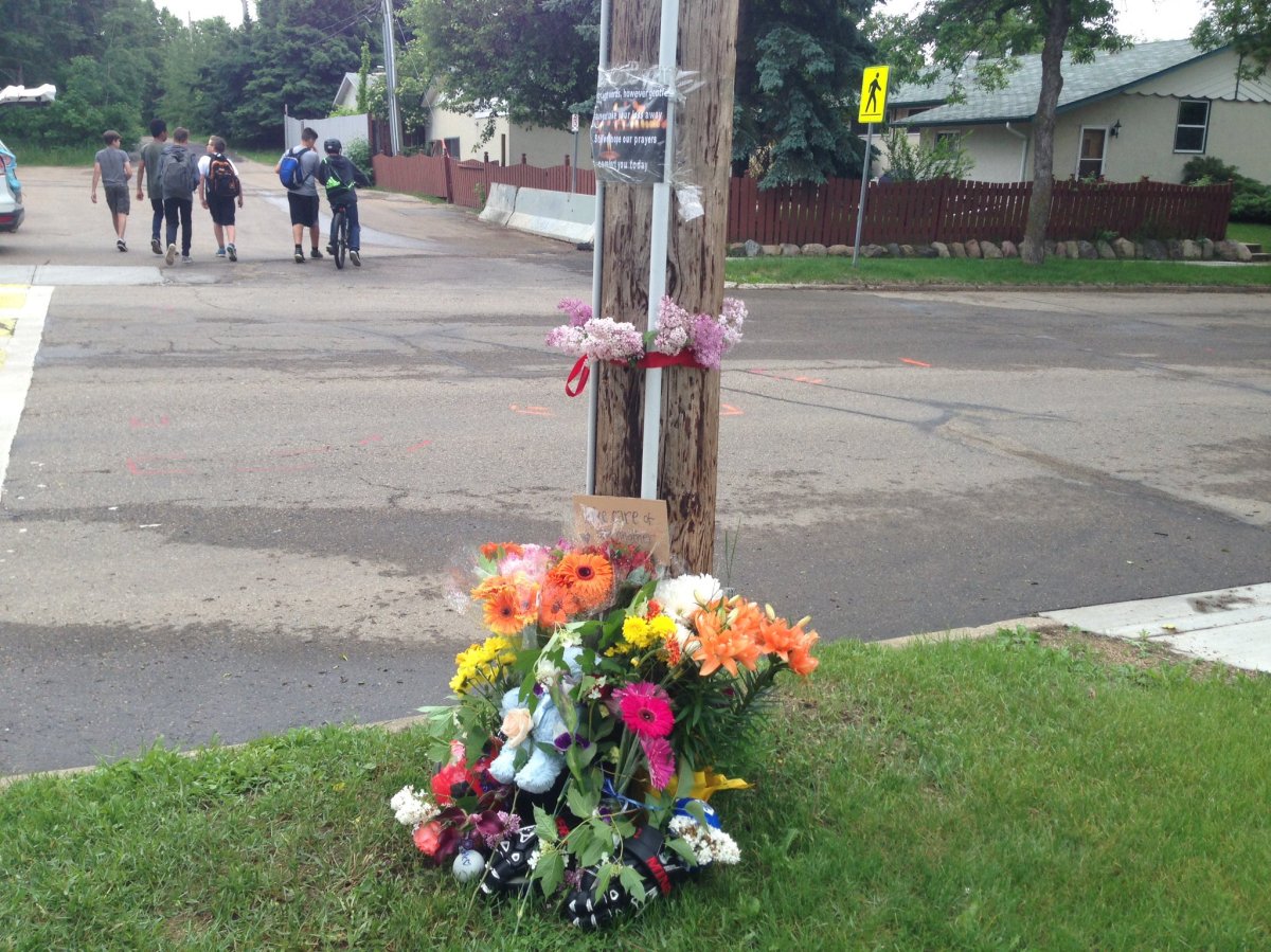 A memorial grows on Friday, June 9, 2017, where a 13-year-old boy was struck and killed while riding his bike Thursday.