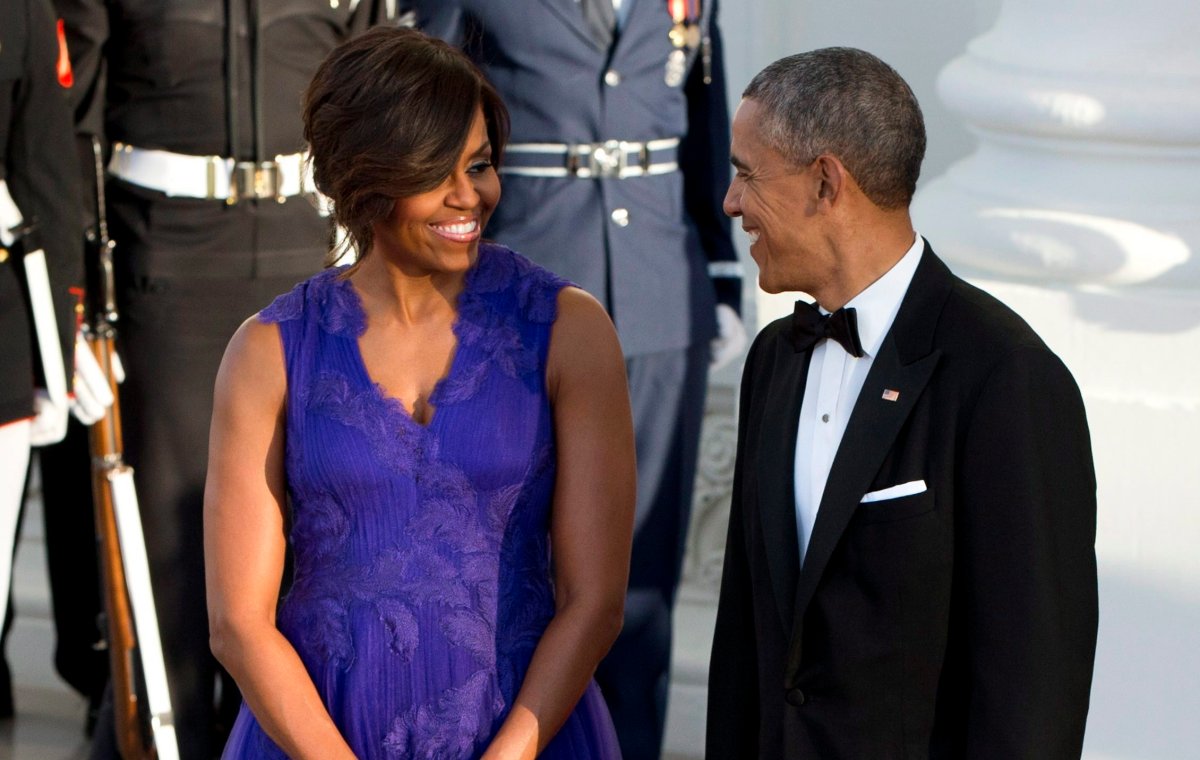 President Barack Obama and first lady Michelle Obama smile at each other as they wait to greet Japanese Prime Minister Shinzo Abe and his wife Akie Abe at the North Portico of the White House as they arrive for a state dinner, Tuesday, April 28, 2015, in Washington. (AP Photo/Jacquelyn Martin).