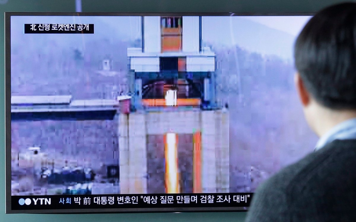 A man watches a TV news program showing an image that North Korea's Rodong Sinmun newspaper reports of a ground test of a new type of high-thrust rocket engine at Seoul Railway station in Seoul, South Korea, Sunday, March 19, 2017. 