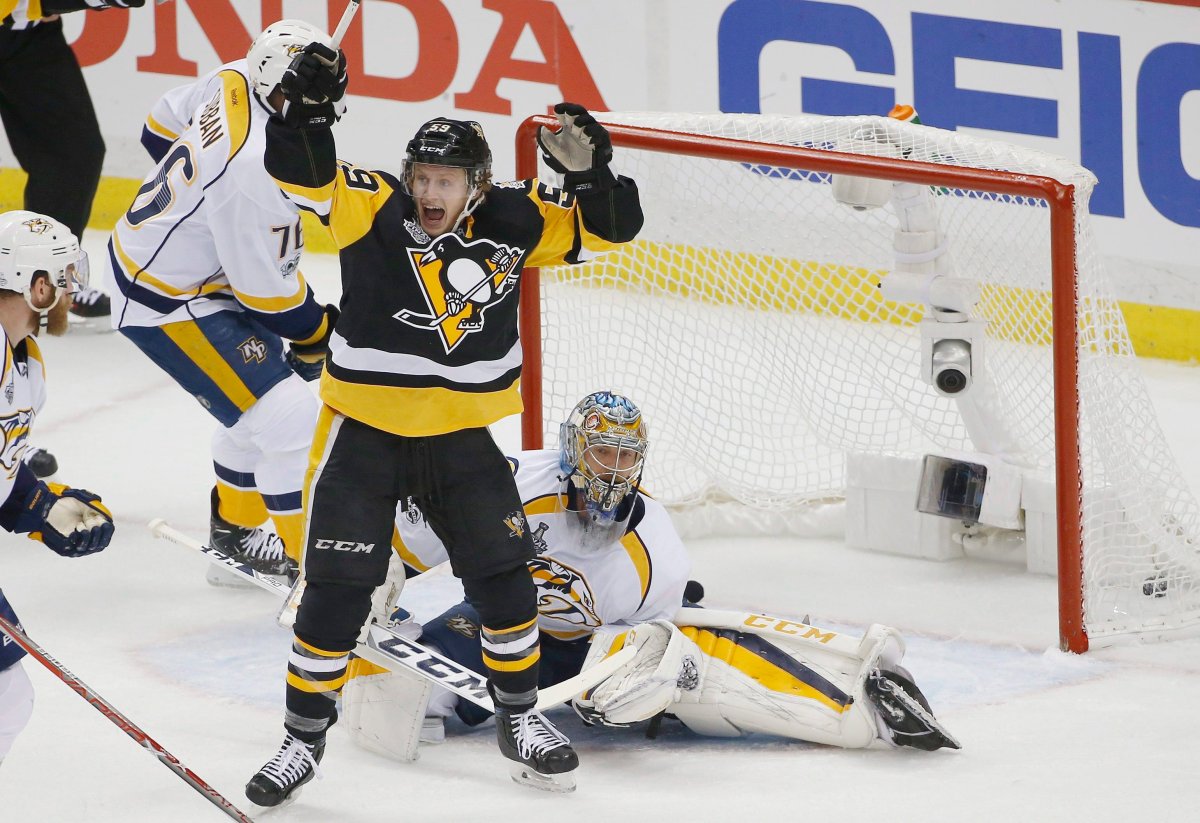 Pittsburgh Penguins' Jake Guentzel, front, celebrates a goal by teammate Evgeni Malkin in front of Nashville Predators goalie Pekka Rinne during the first period in Game 1 of the NHL hockey Stanley Cup Final, Monday, May 29, 2017, in Pittsburgh. (AP Photo/Gene J. Puskar).
