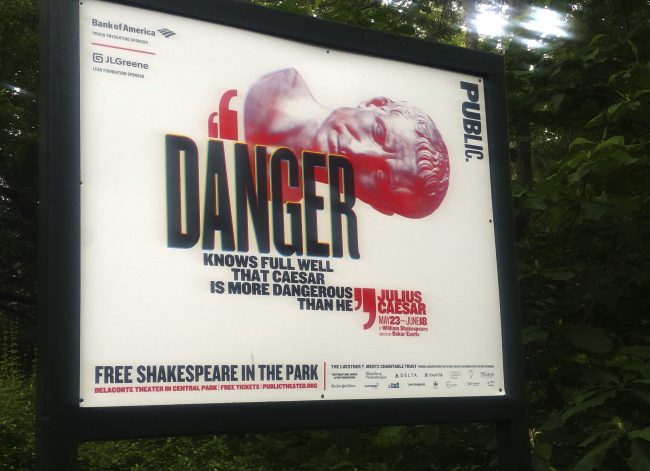 A sign promoting The Public Theater's production of Julius Caesar in New York's Central Park, June 7, 2017. 