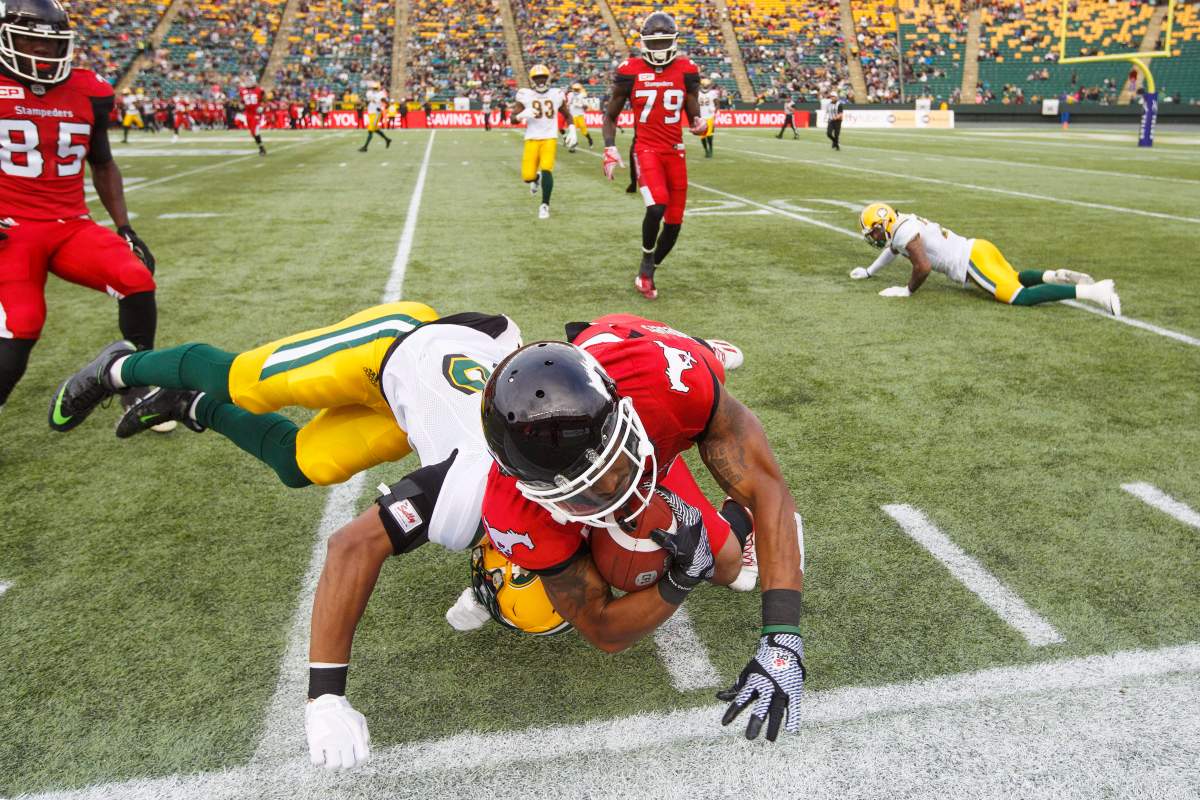 Calgary Stampeders Jamal Nixon (80) gets run out of bounds by Edmonton Eskimos Arjen Colquhoun (36) during second half CFL pre-season action in Edmonton, Alta., on Sunday June 11, 2017. The Stampeders won 36-35. THE CANADIAN PRESS/Amber Bracken
