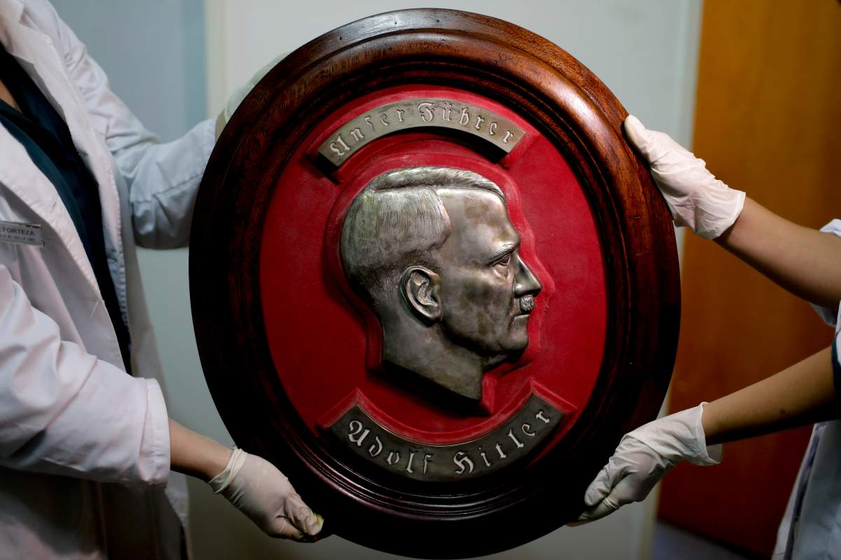 Members of the federal police show a bust relief portrait of Nazi leader Adolf Hitler at the Interpol headquarters in Buenos Aires, Argentina, Friday, June 16, 2017.
