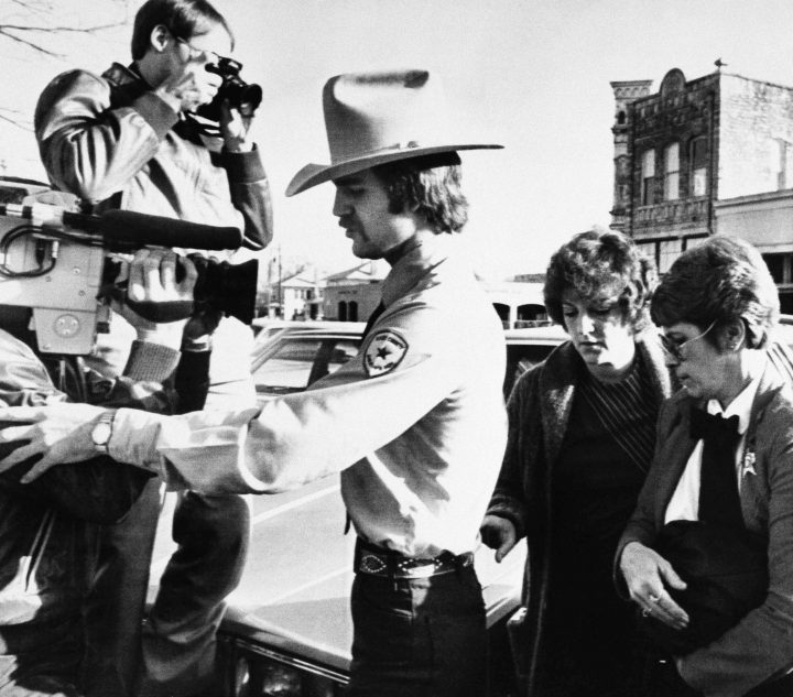 In this Feb. 16, 1984 file photo, nurse Genene Jones, in custody of Kerr County Deputy Clay Barton, left, and Williamson County Deputy Loretta Pickett, right, arrives at Williamson County Courthouse in Georgetown, Texas.