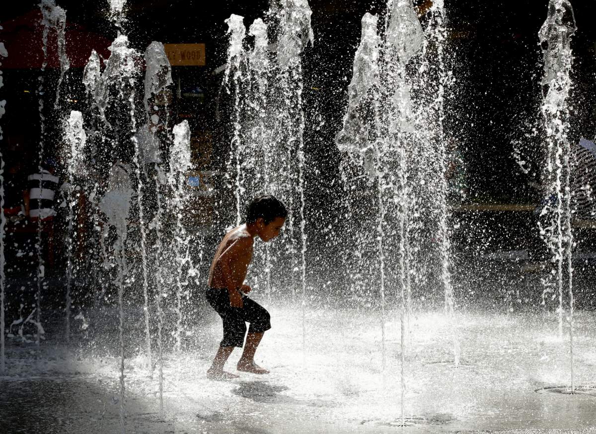 Three-year-old Leo Estrada runs through a water fountain at the Hollywood & Highland entertainment center in Hollywood, California, USA, 21 June 2017.