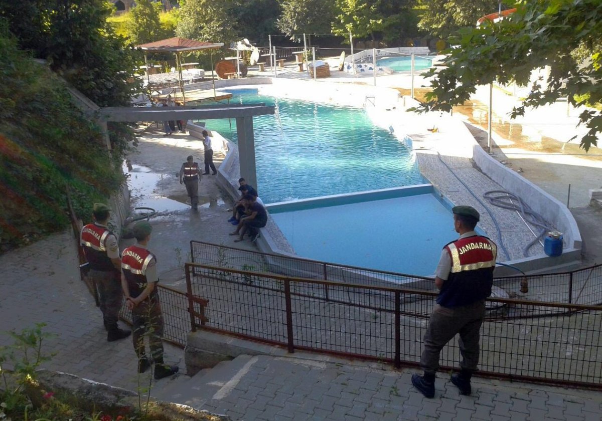 Paramilitary police officers investigate after five people were caught up in an electrical current in the pool and died at the park in the town of Akyazi, in Sakarya province, western Turkey, Friday.