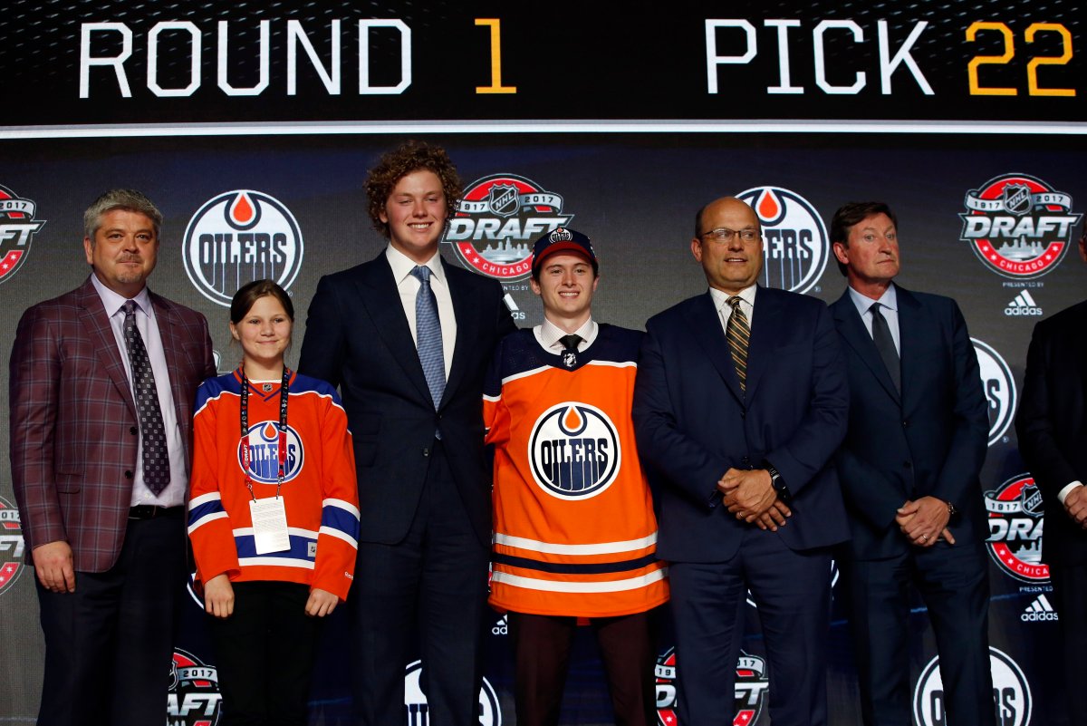 Kailer Yamamoto, center, wears an Edmonton Oilers jersey after being selected by the team during the first round of the NHL hockey draft, Friday, June 23, 2017, in Chicago. (AP Photo/Nam Y. Huh).