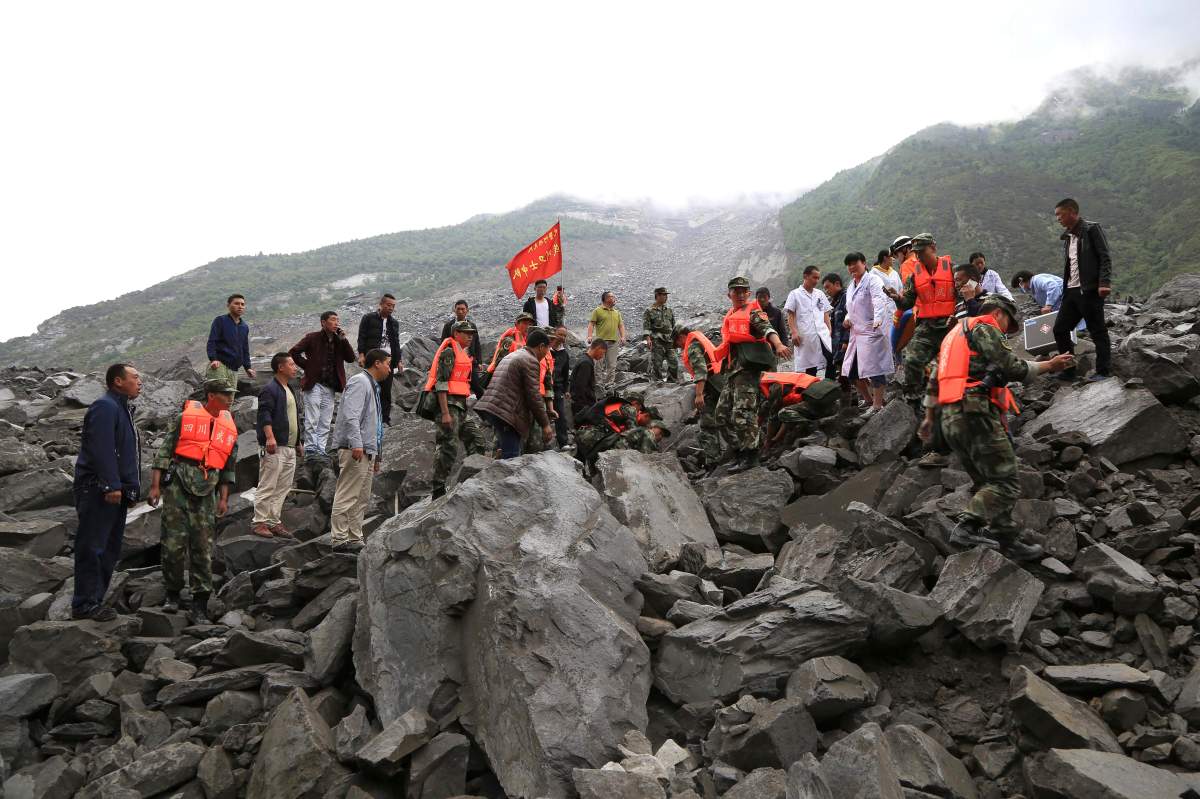 In this photo released by China\’s Xinhua News Agency, emergency personnel work at the site of a landslide in Xinmo village in Maoxian County in southwestern China\’s Sichuan Province, Saturday, June 24, 2017.