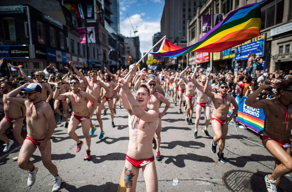 People take part in the Pride parade in Toronto, Sunday, June 25, 2017.