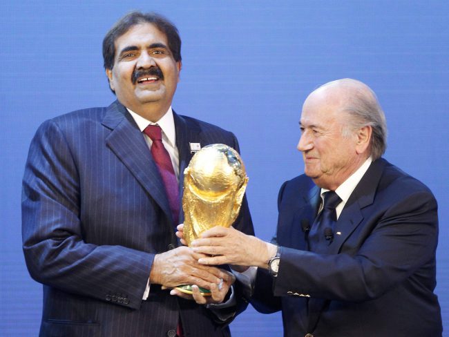 Sheikh Hamad bin Khalifa Al-Thani, Emir of Qatar, is given the World Cup trophy by FIFA President Joseph Blatter after the announcement of Qatar hosting the 2022 soccer World Cup in Zurich, Switzerland., Dec. 2, 2010.