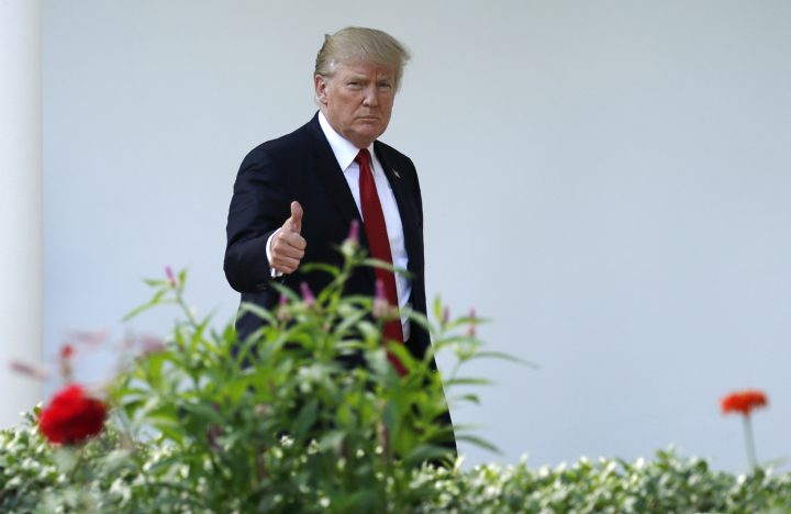 U.S. President Donald Trump gives a thumbs up as he walks up the West Wing colonnade in Washington.