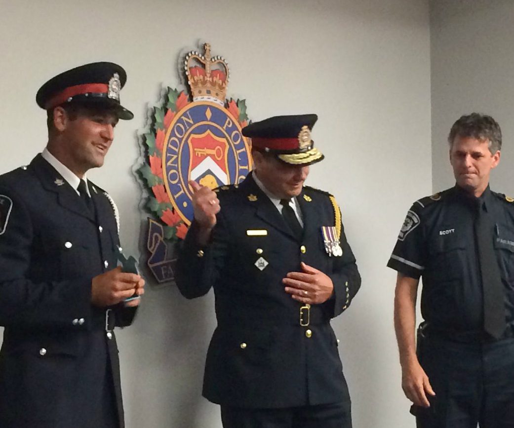 Const. Hopkins (left) with London Police Chief John Pare and Scott Ruddle of London-Middlesex EMS at a June 2017 police board meeting.