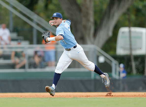 Logan Warmoth #7 of the North Carolina Tar Heels fields the ball hit by Edgar Michelangeli #16 (not pictured) of the Miami Hurricanes on April 3, 2016 at Alex Rodriguez Park at Mark Light Field in Coral Gables, Florida. (Photo by Joel Auerbach/Getty Images).