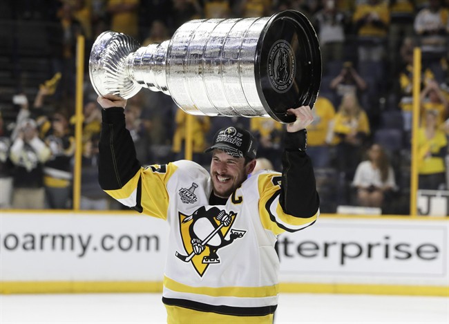 Pittsburgh Penguins' Sidney Crosby (87) celebrates with the Stanley Cup after defeating the Nashville Predators in Game 6 of the NHL hockey Stanley Cup Final, Sunday, June 11, 2017, in Nashville, Tenn. (AP Photo/Mark Humphrey).