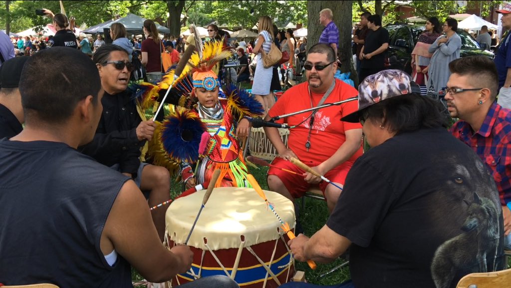 A young boy in traditional regalia joins a drum circle, during and Intertribal Dance on June 21, 2017.