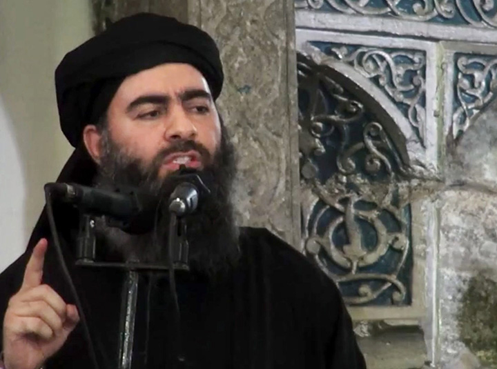 This file image, made from video posted on a militant website Saturday, July 5, 2014, purports to show the leader of the Islamic State group, Abu Bakr al-Baghdadi, delivering a sermon at a mosque in Iraq during his first public appearance. 