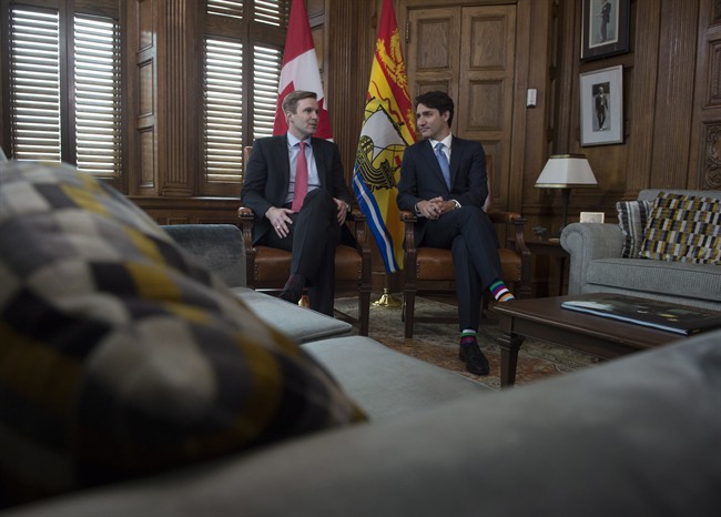 Canadian Prime Minister Justin Trudeau speaks with New Brunswick Premier Brian Gallant at the start of a meeting on Parliament Hill in Ottawa, Friday June 2, 2017.