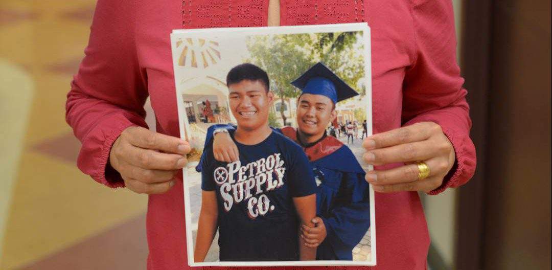 Mercedes Benitez holds a photo of her son Harold (left) and Bill (right).