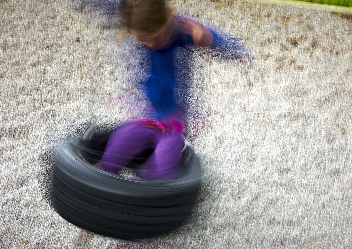 FILE PHOTO: A child plays on a tire swing at a playground Alberta.