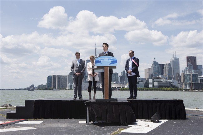 Canadian Prime Minister Justin Trudeau stands alongside Ontario Premier Kathleen Wynne, Toronto Mayor John Tory and Toronto Waterfront CEO William Fleissig (right) as he makes a funding announcement in Toronto on Wednesday, June 28, 2017.