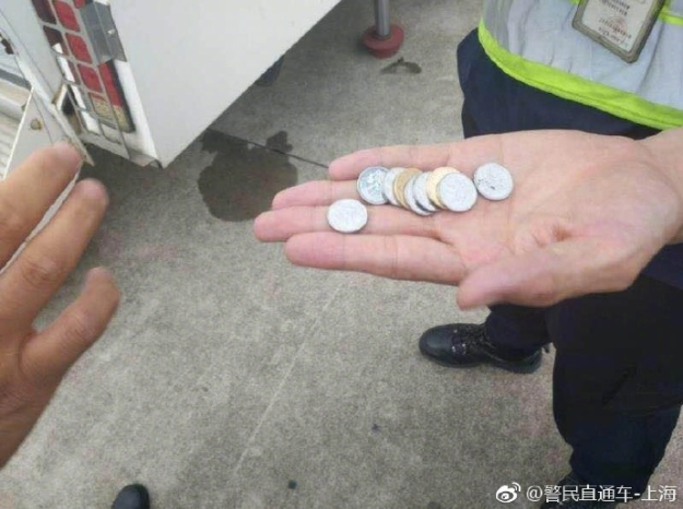 Shanghai police shared a photo of the coins a passenger tossed for good luck prior to a Shanghai flight. 