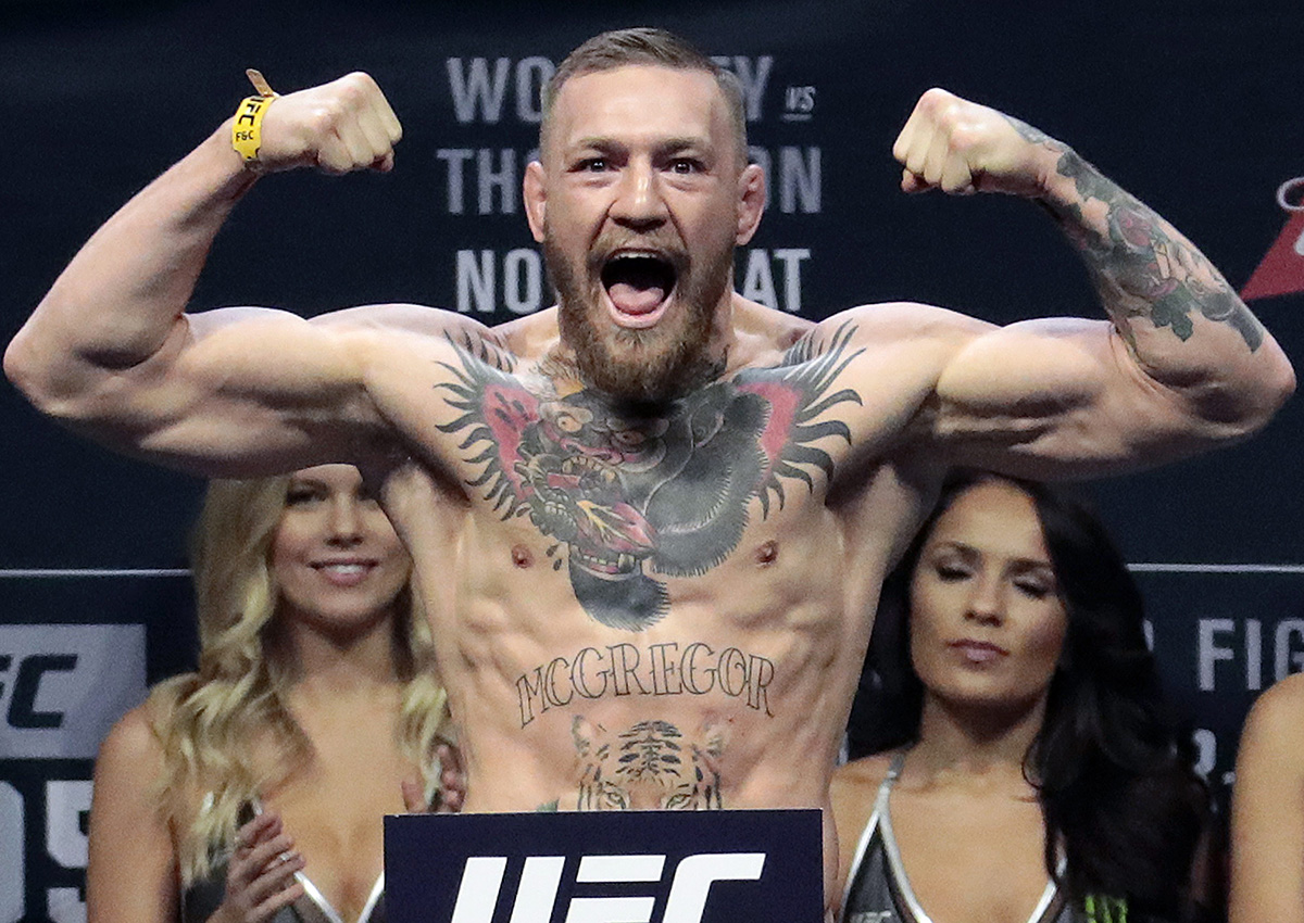In this Nov. 11, 2016, file photo, Conor McGregor stands on a scale during the weigh-in event for his fight against Eddie Alvarez in UFC 205 mixed martial arts at Madison Square Garden in New York.