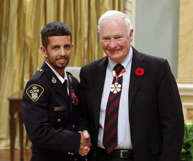 Ontario Provincial Police Const. Robert Conant, of Stoney Creek, Ont., receives the Medal of Bravery from Governor General David Johnston during the Bravery Awards at Rideau Hall, in Ottawa on Friday, October 28, 2016.