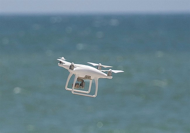 A drone flies over the water at Capistrano Beach in search of sharks in Dana Point, Calif., on Thursday, May 11, 2017. 