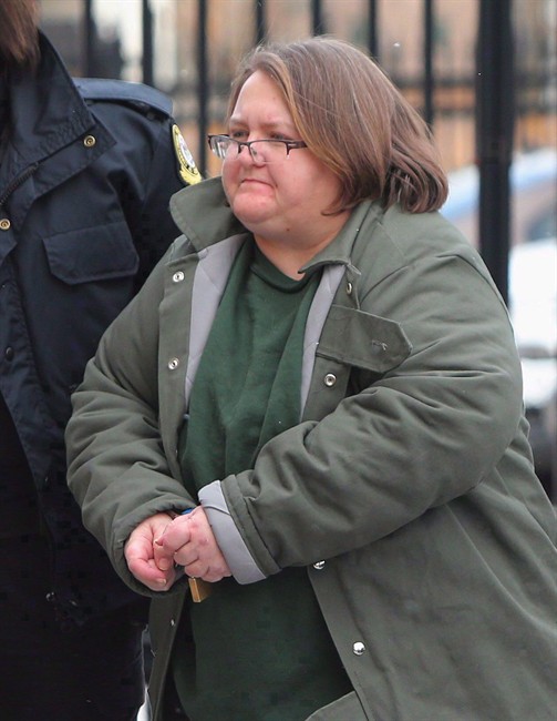 Elizabeth Wettlaufer is escorted into the courthouse in Woodstock, Ont. on Friday, Jan. 13, 2017. T.
