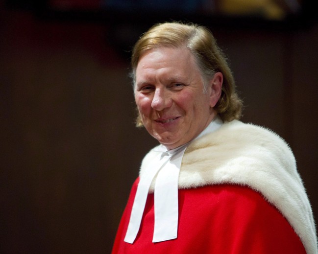 Justice Malcolm Rowe smiles as he stands before his colleagues of the Supreme Court as he is welcomed during a ceremony at the Supreme Court, in Ottawa, Friday, December 2, 2016.