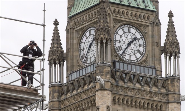 A police officer surveys the grounds in front of Parliament in Ottawa Wednesday, June 29, 2016. 