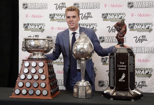 Connor McDavid of the Edmonton Oilers poses with the Art Ross Trophy, left, the Hart Memorial Trophy, center, and the Ted Lindsay Award after winning the honors during the NHL Awards, Wednesday, June 21, 2017, in Las Vegas. 