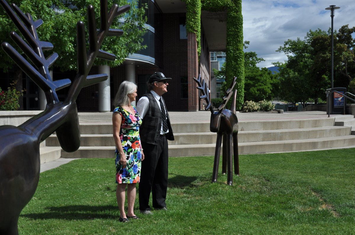 Louise Sidley, left, and David Sidley speak to family and friends gathered after the sculpture “Two Deer” was officially unveiled at UBC’s Okanagan campus. 