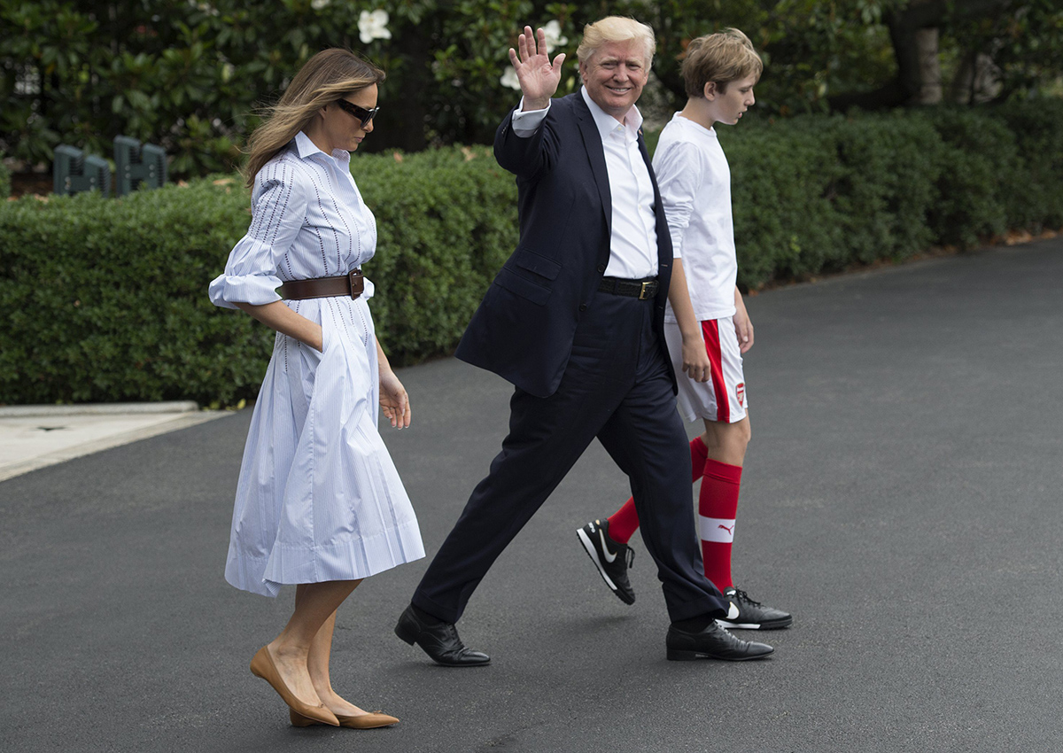 Donald Trump walks to Marine One with first lady Melania and their son Barron, as they depart the White House for Camp David.