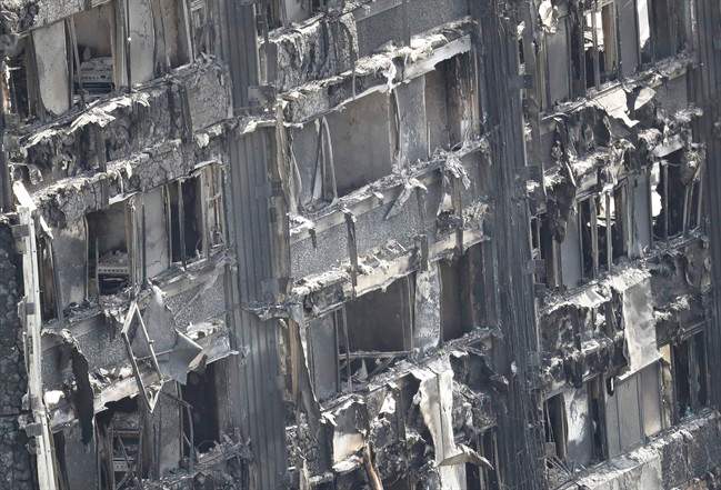 Part of the scorched facade of the Grenfell Tower in London as firefighting continue to damp-down the deadly fire on June 15.