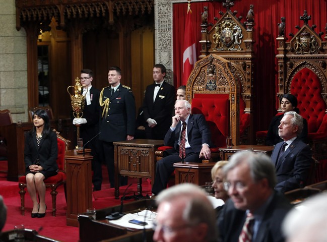 Governor General David Johnston takes part in Royal Assent along with Senator Peter Harder, right, and Bardish Chagger Leader of the Government in the House of Commons, in the Senate on Parliament Hill in Ottawa on Monday, June 19, 2017. 