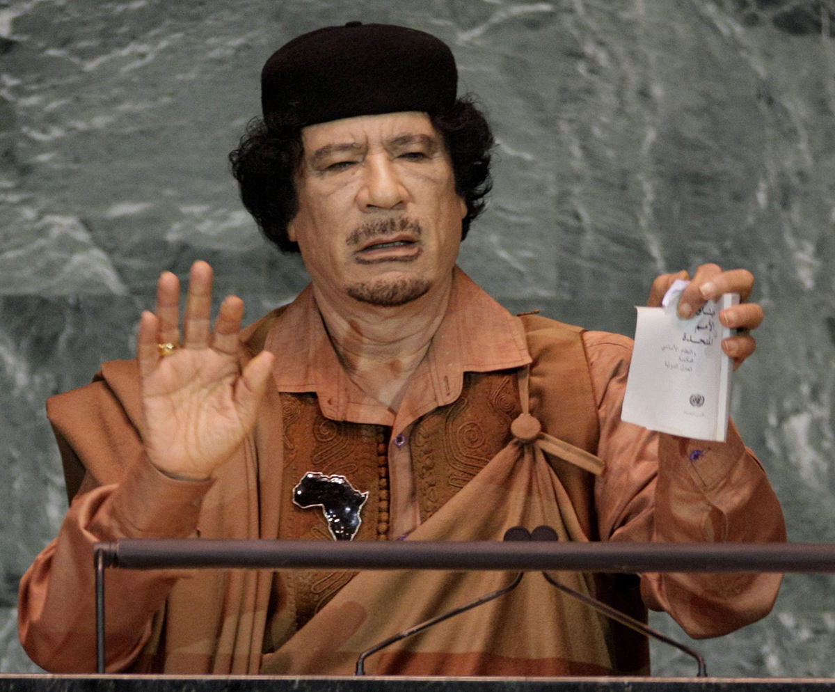 In this Sept. 23, 2009 photo, Libyan leader Moammar Gadhafi shows a torn copy of the UN Charter during his address to the 64th session of the United Nations General Assembly.