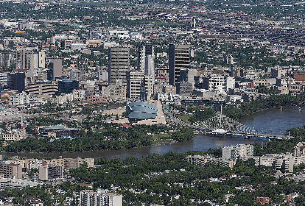WINNIPEG, MB –  An aerial view of the Winnipeg skyline by the Red River on June 15, 2013 in Winnipeg, Manitoba. (Photo by Tom Szczerbowski/Getty Images)
