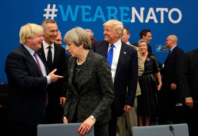 British Foreign Minister Boris Johnson (L), U.S. President Donald Trump and NATO Secretary- U.S. President Donald Trump (C) reacts while speaking to NATO Secretary General Jens Stoltenberg (2-L) and British Foreign Minister Boris Johnson (L) as Britain's Prime Minister Theresa May passes during a working dinner meeting at the NATO (North Atlantic Treaty Organization) headquarters in Brussels on May 25, 2017 during a NATO summit.
