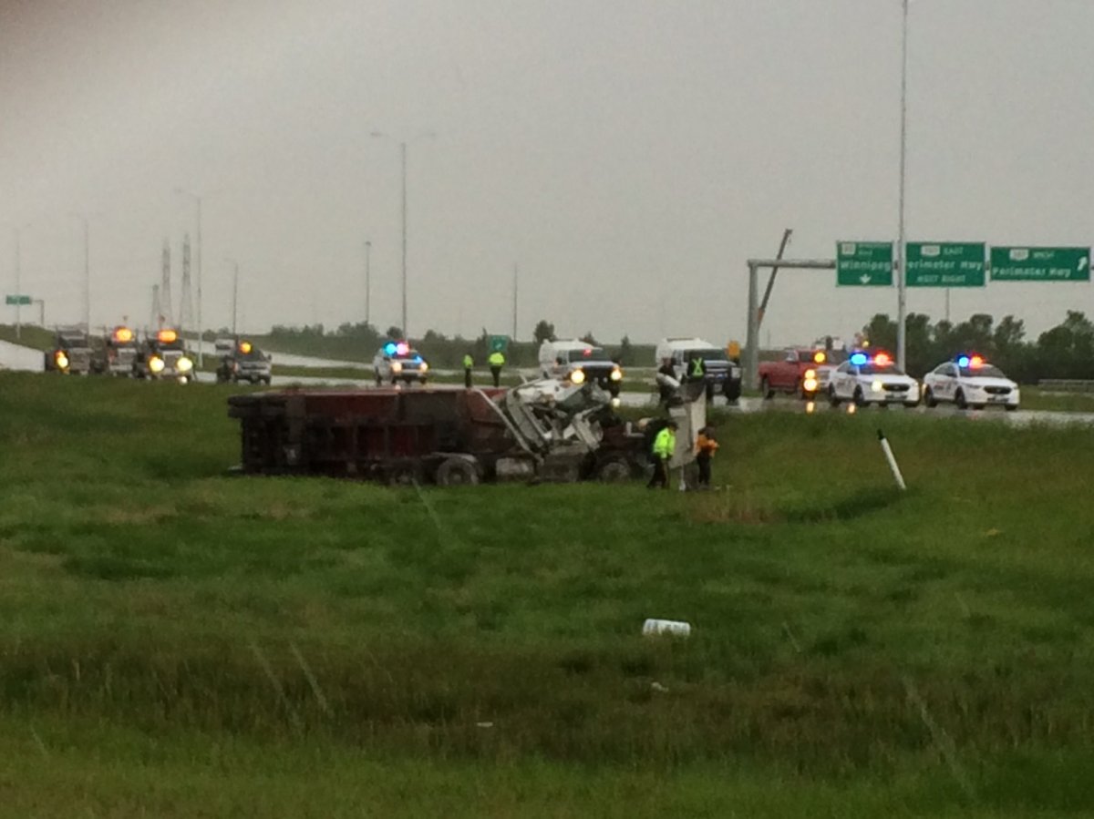 Police have surrounded a semi-trailer flipped on its side.