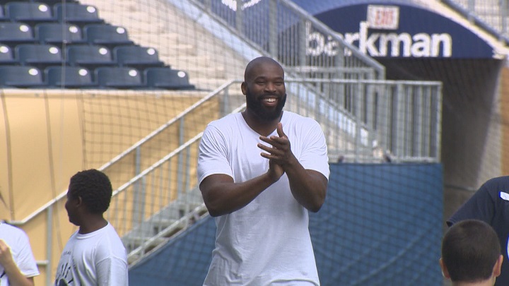 Israel Idonije watches on during his annual All-Star Football Camp at Investors Group Field in 2016.