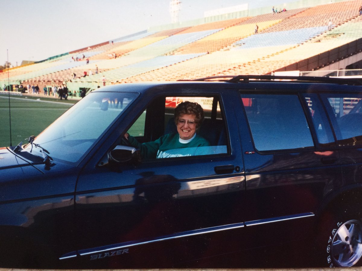 My grandma driving her 1991 Chevrolet Blazer off the field after winning it in the Rider Raffle.