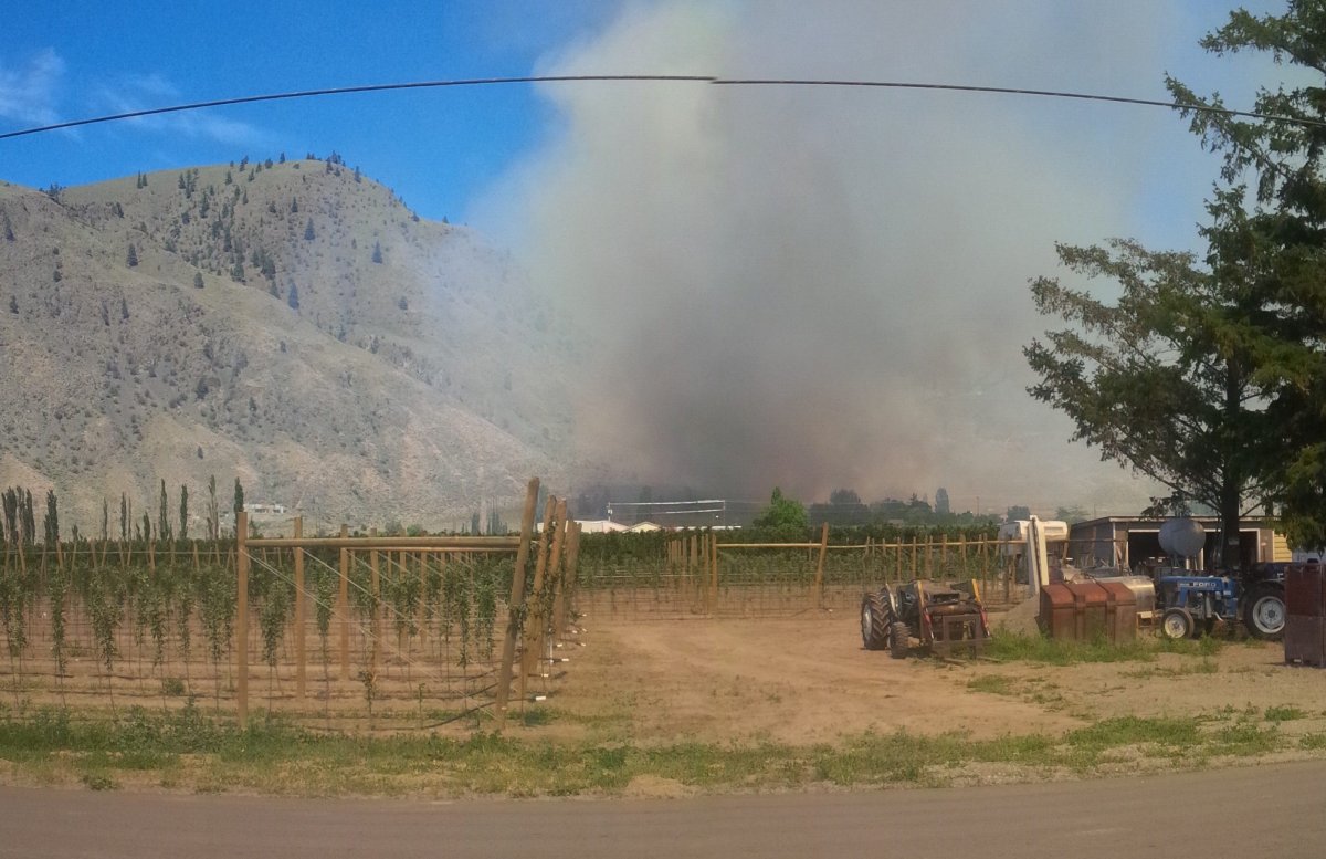 It is unknown what structures may be near a grass fire that is producing dark smoke in Cawston. 