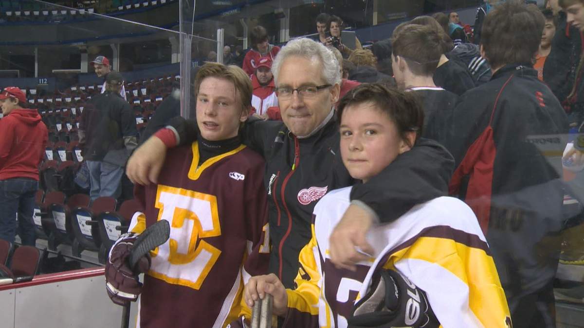 Jaret-Anderson Dolan poses with Tom Renney and his friend Nick Unruh after skating with the Detroit Red Wings in March of 2013.