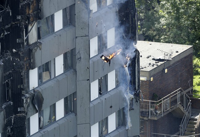 Burning debris falls from a massive fire that raged in a high-rise apartment building in London, Wednesday, June 14, 2017. A deadly night-time fire raced through a 24-story apartment tower in London early Wednesday, killing at least six people and injuring dozens more.