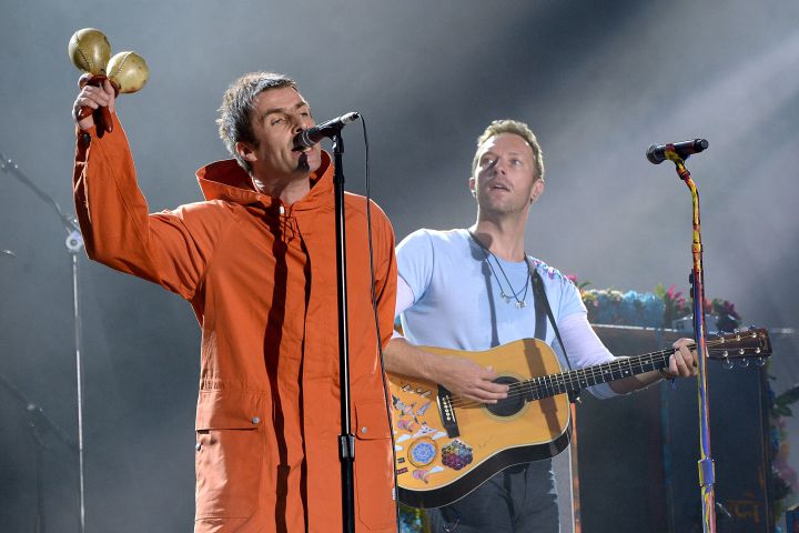 Liam Gallagher (L) and Chris Martin of Coldplay perform on stage during the One Love Manchester Benefit Concert at Old Trafford Cricket Ground on June 4, 2017 in Manchester, England.
