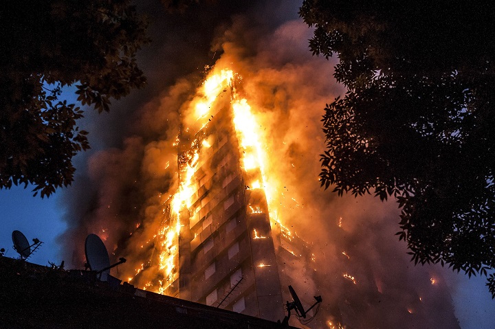Falling burning debris at the scene of a huge fire at Grenfell tower block in London, UK, June 14, 2017.