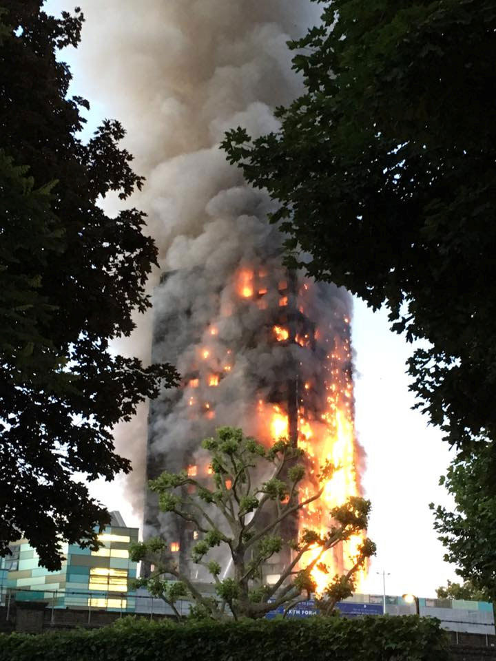 Flames and smoke billow from a tower block
